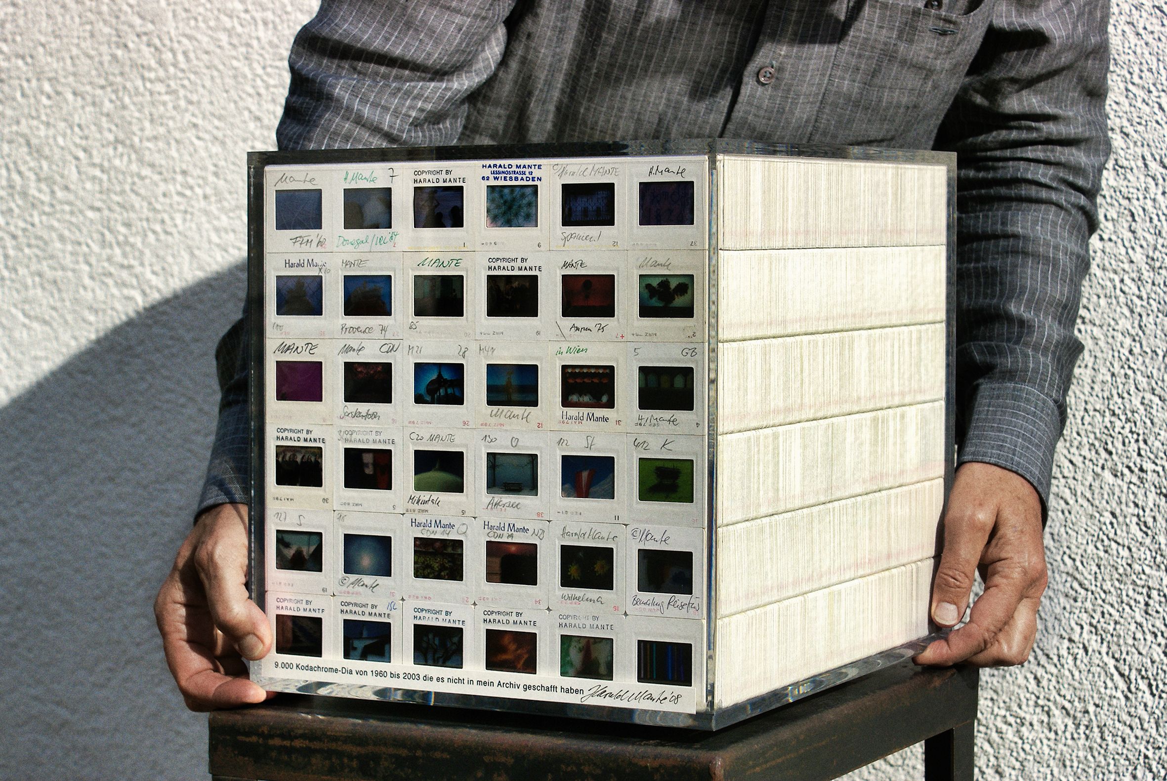 Harald Mante hält Acrylglaswürfel mit 9.000 Kodachrome-Dias (1960–2003), 2008